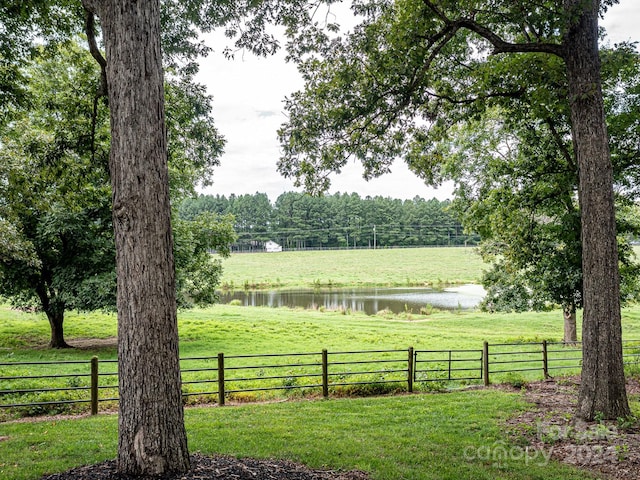 view of yard featuring a water view and a rural view