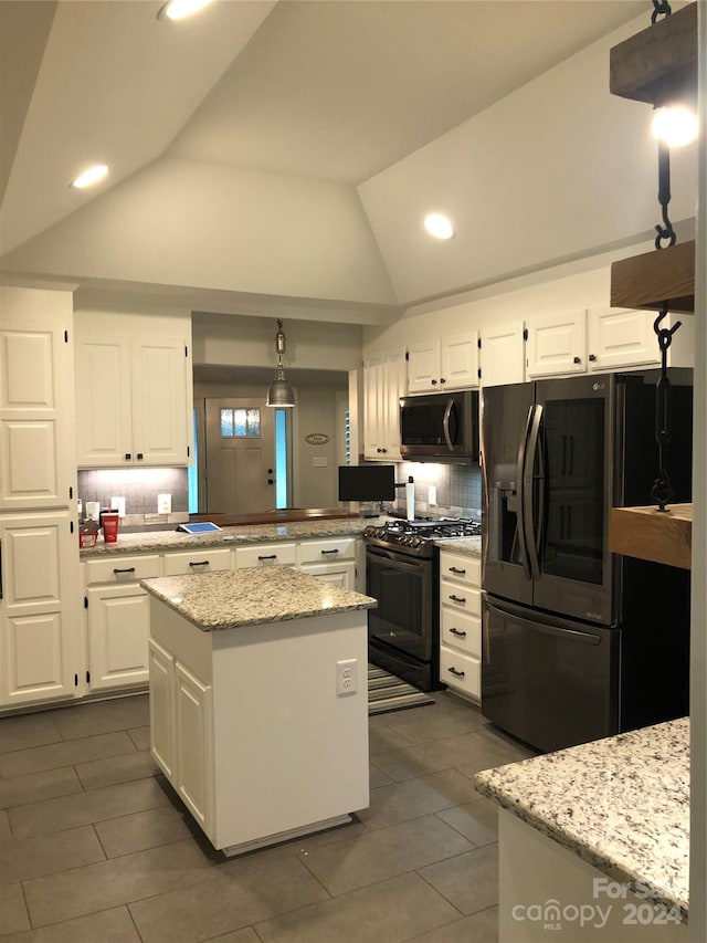 kitchen with black gas range, white cabinets, pendant lighting, vaulted ceiling, and fridge with ice dispenser