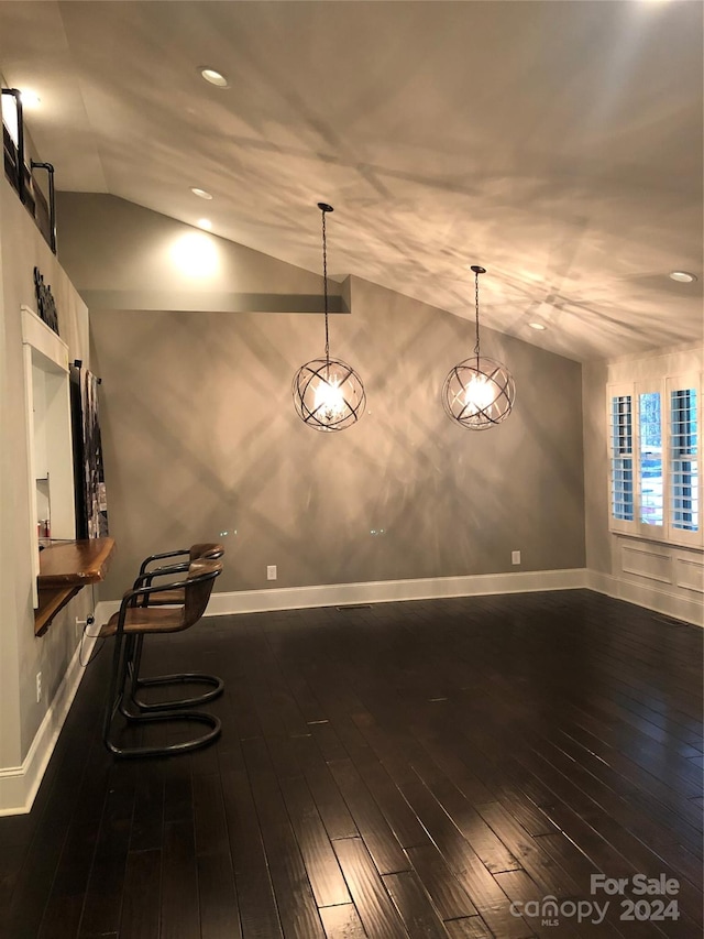 interior space with vaulted ceiling and dark hardwood / wood-style floors