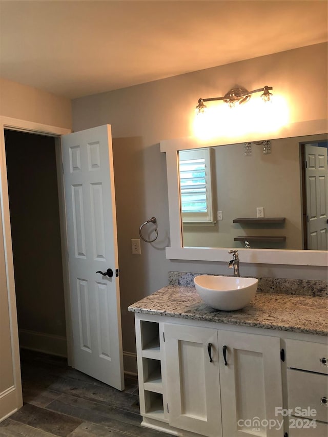 bathroom featuring vanity and wood-type flooring