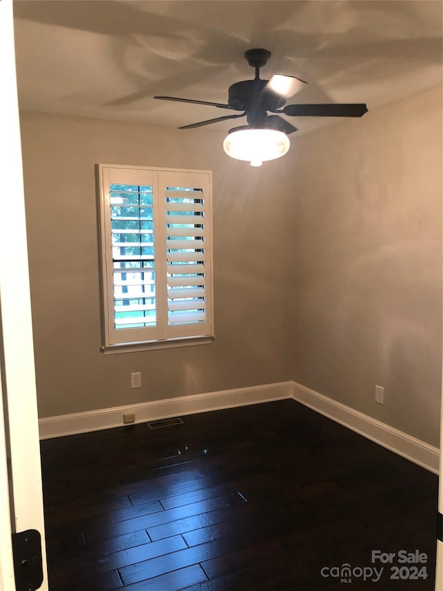 spare room with hardwood / wood-style flooring and ceiling fan