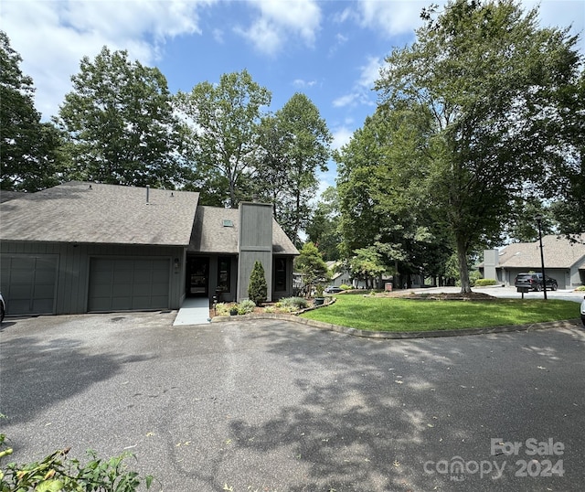 view of front of home featuring a garage and a front lawn