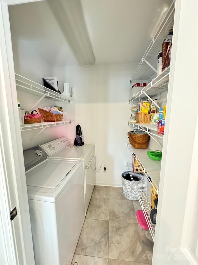 laundry area featuring independent washer and dryer and light tile patterned floors