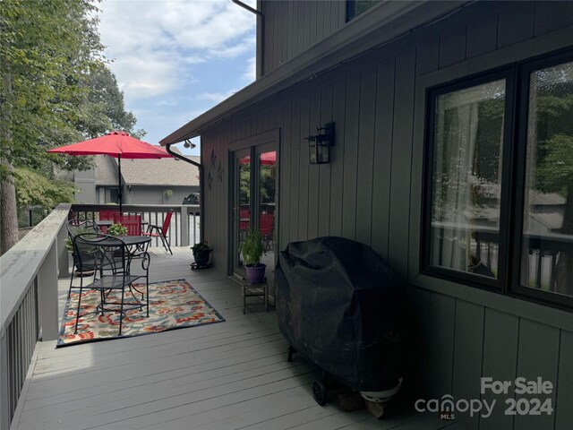 wooden terrace with area for grilling