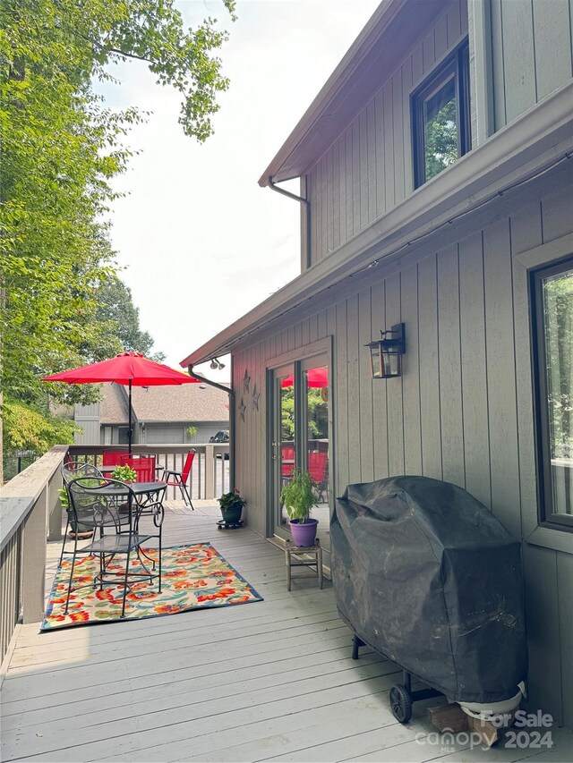 wooden terrace featuring area for grilling