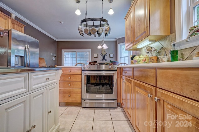 kitchen with light tile patterned floors, crown molding, hanging light fixtures, backsplash, and stainless steel appliances