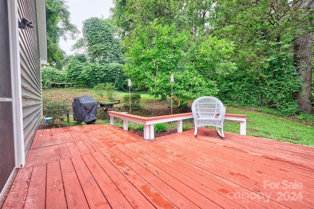 wooden terrace featuring a grill