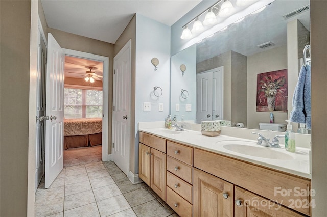 bathroom with vanity, tile patterned flooring, and toilet