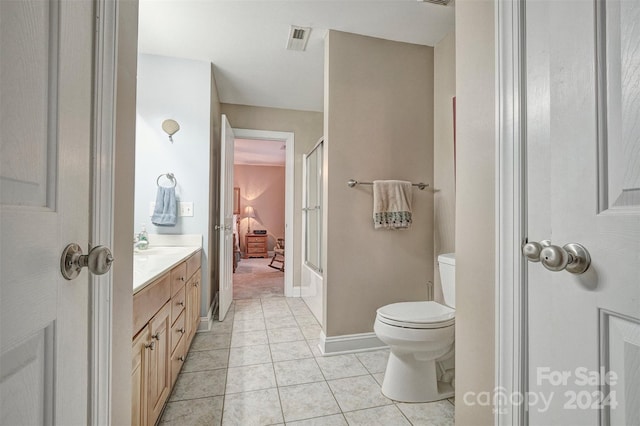 full bathroom featuring tile patterned flooring, vanity, enclosed tub / shower combo, and toilet