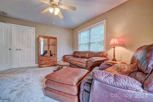 carpeted living room with ceiling fan