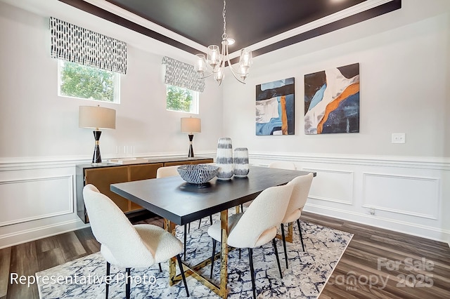 dining area with ornamental molding, dark hardwood / wood-style floors, and a chandelier