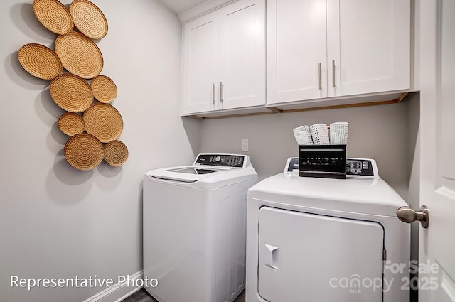 laundry room featuring cabinets and washer and clothes dryer