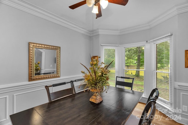 dining space with ornamental molding and ceiling fan