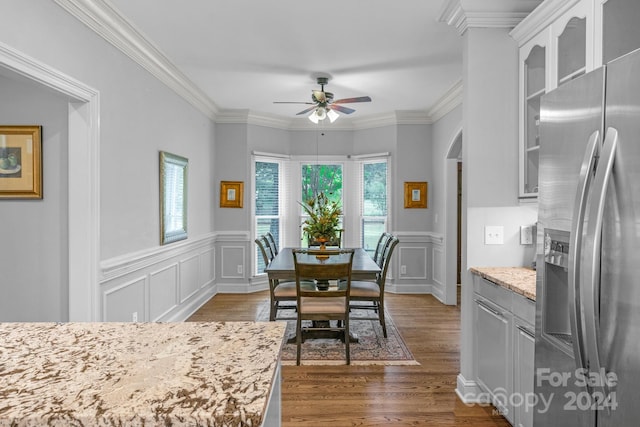 dining area featuring ornamental molding, dark hardwood / wood-style floors, and ceiling fan