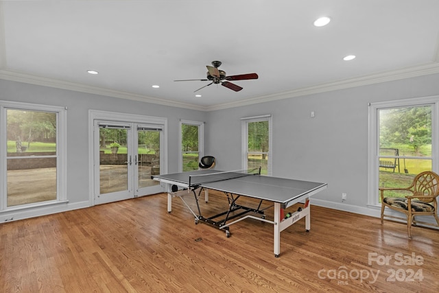 recreation room featuring french doors, ceiling fan, crown molding, and light wood-type flooring