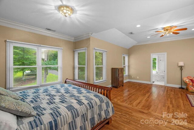 bedroom with ornamental molding, wood-type flooring, and multiple windows