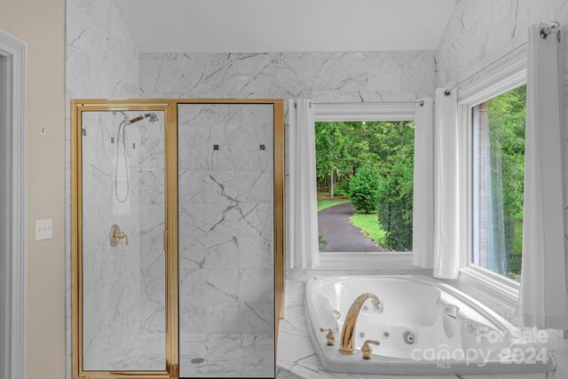 bathroom with plenty of natural light and independent shower and bath