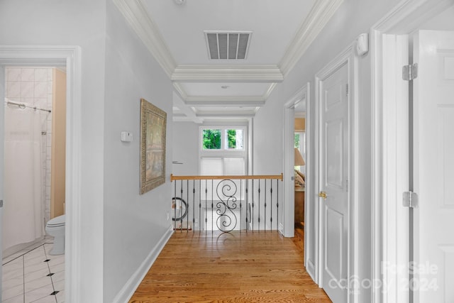 corridor with ornamental molding, coffered ceiling, beam ceiling, and light hardwood / wood-style flooring