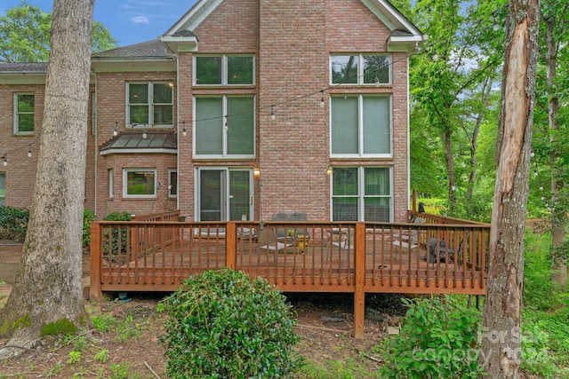 rear view of property with a wooden deck