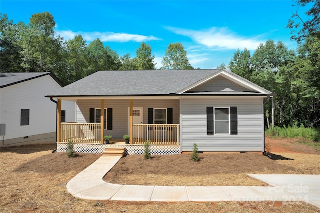 single story home with crawl space, covered porch, and a shingled roof