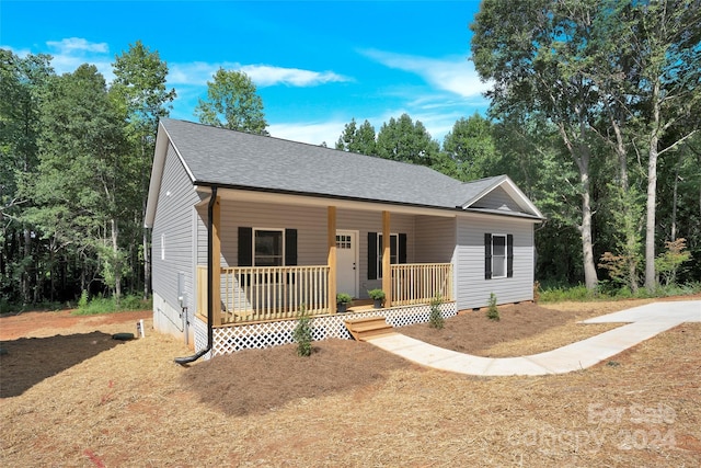 view of front of home featuring a porch, crawl space, and roof with shingles