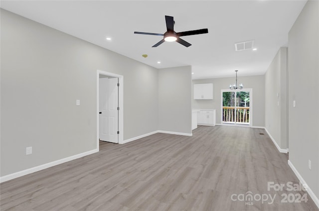 unfurnished living room with light wood-type flooring and ceiling fan with notable chandelier