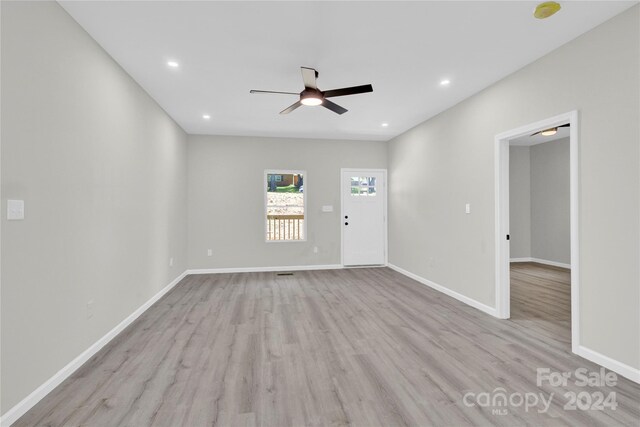 spare room with light wood-type flooring and ceiling fan