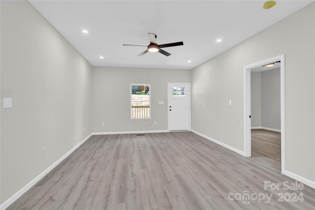 unfurnished living room featuring recessed lighting, wood finished floors, a ceiling fan, and baseboards