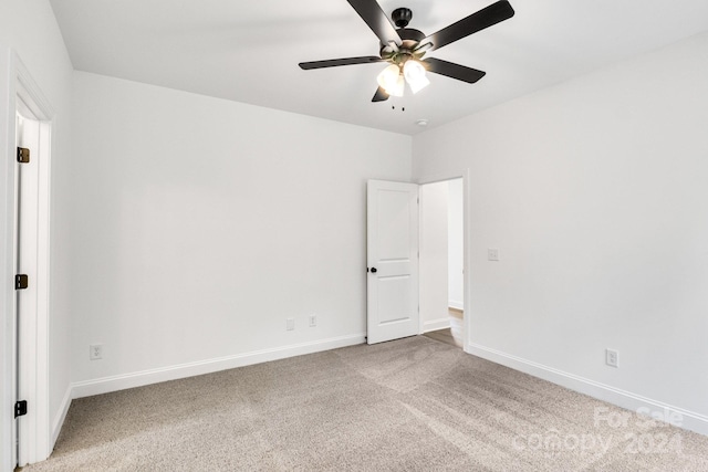 empty room with light colored carpet and ceiling fan