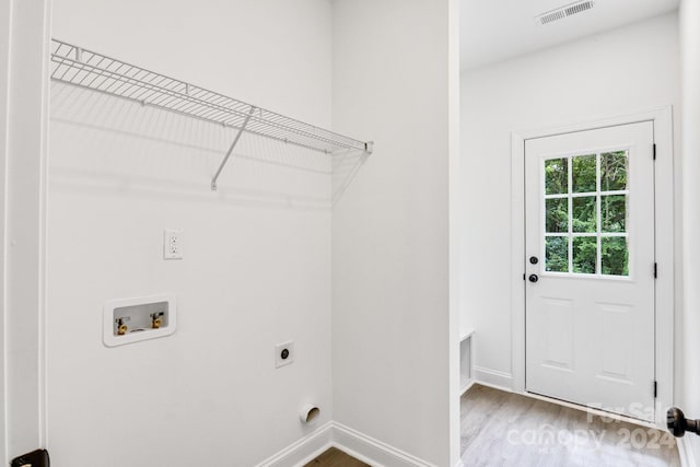 laundry room with hookup for an electric dryer, light wood-type flooring, and hookup for a washing machine