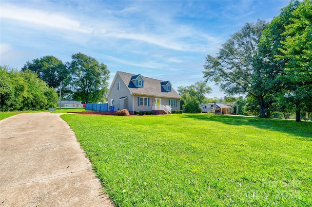 cape cod house with a front lawn