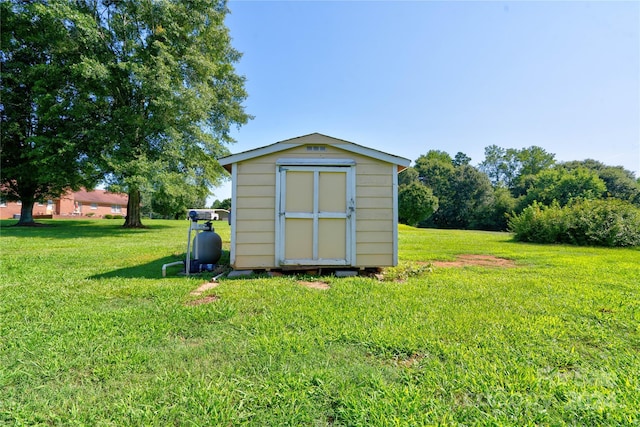 view of outbuilding with a yard