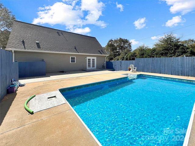 view of swimming pool with a patio area and french doors