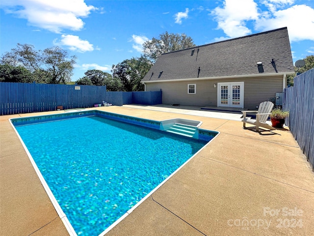 view of pool with a patio and french doors