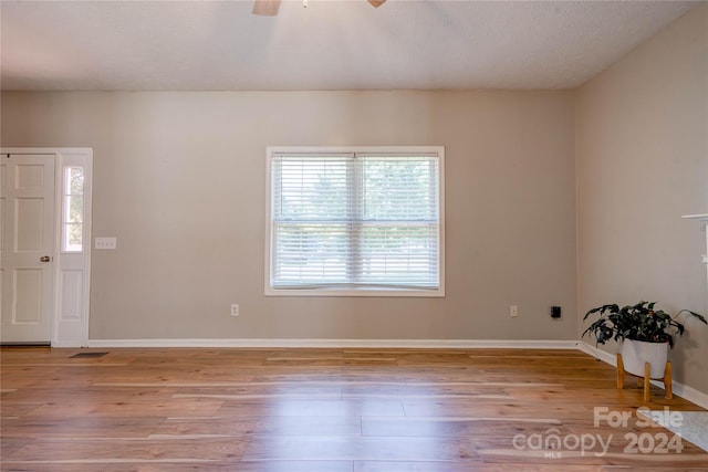 unfurnished room featuring ceiling fan and light wood-type flooring