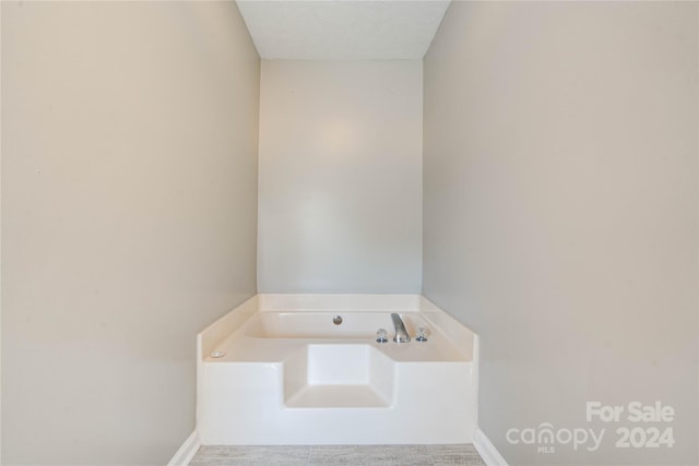 bathroom featuring a bathing tub and a textured ceiling