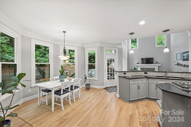 kitchen with light hardwood / wood-style floors, plenty of natural light, and gray cabinetry