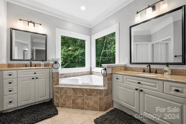 bathroom with tile patterned flooring, tiled tub, dual vanity, and ornamental molding