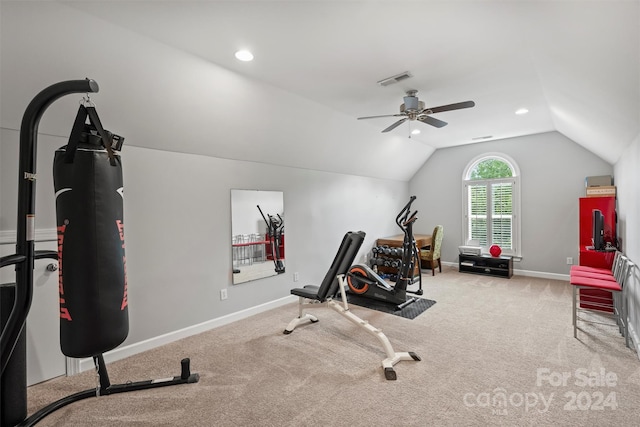 exercise room with light carpet, ceiling fan, and vaulted ceiling