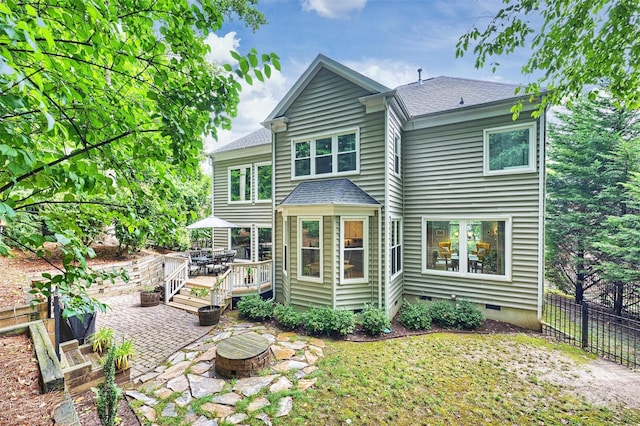 back of house featuring a patio area and a wooden deck