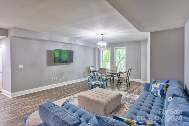 living room with a notable chandelier and dark hardwood / wood-style floors