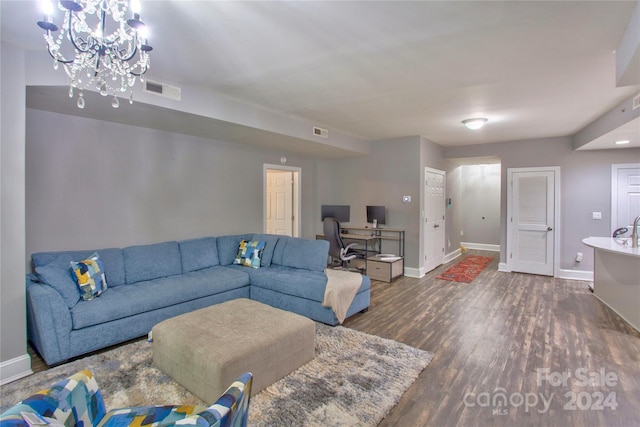 living room featuring dark hardwood / wood-style floors and a notable chandelier