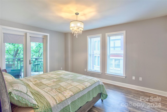 bedroom featuring a notable chandelier, access to outside, and hardwood / wood-style flooring