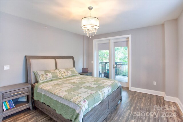 bedroom with dark hardwood / wood-style floors, french doors, access to exterior, and an inviting chandelier