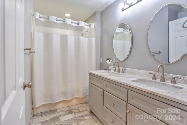 bathroom featuring tile patterned flooring and double vanity