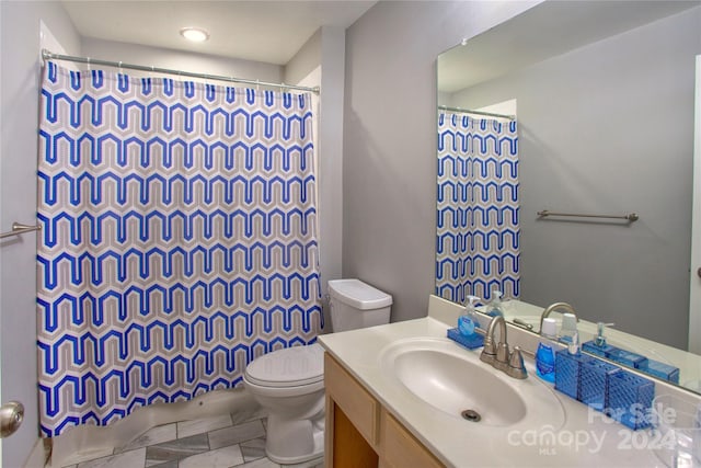 bathroom with tile patterned floors, vanity, and toilet