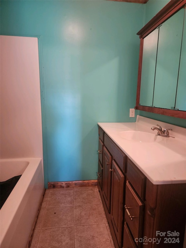 bathroom with vanity, tile patterned flooring, and a tub