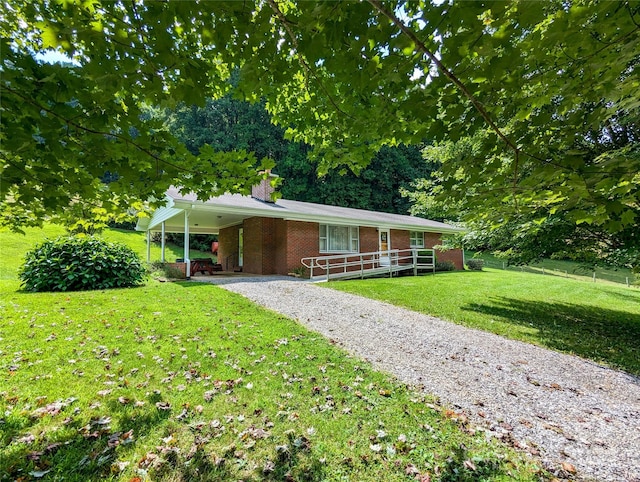 ranch-style home with a carport and a front lawn