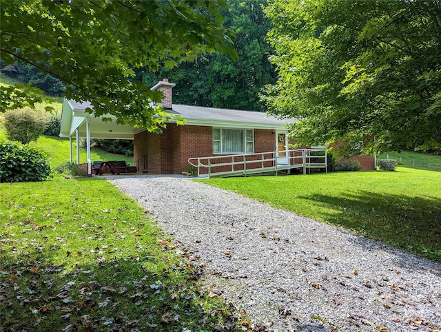 ranch-style home with a carport and a front lawn