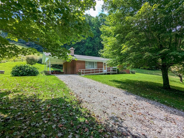 ranch-style house with a carport and a front lawn